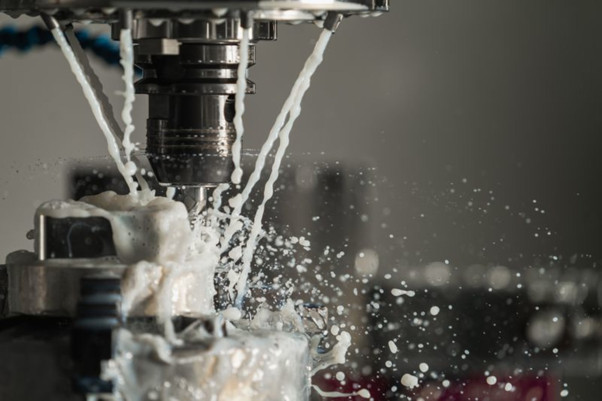 CNC Metal Machining with Coolant Close-up of a CNC cutting tool machining metal with coolant flowing over the workpiece