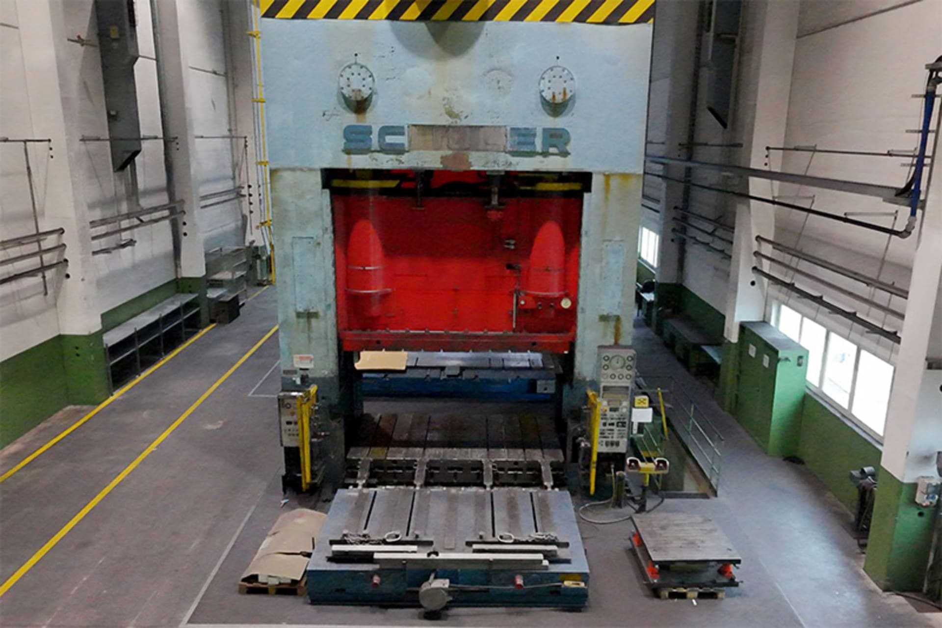 SCHULER P4 E2 SQ 1200 mechanical press with a red ram and a press table extending forward, viewed from above