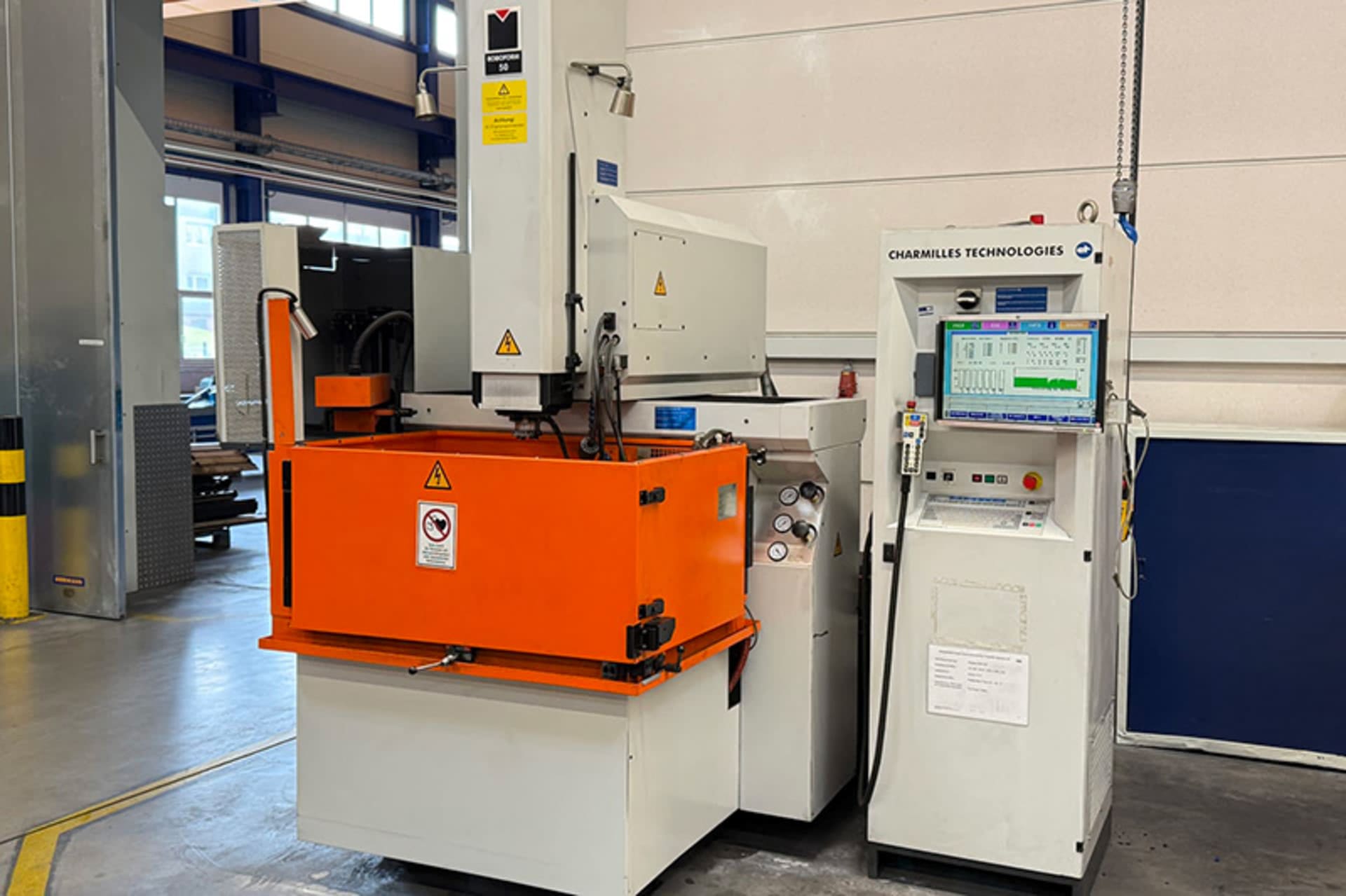 CHARMILLES ROBOFORM 50 Sinker EDM Machine CHARMILLES ROBOFORM 50 sinker EDM machine with a vertical machining head, an orange work tank, and a separate control cabinet