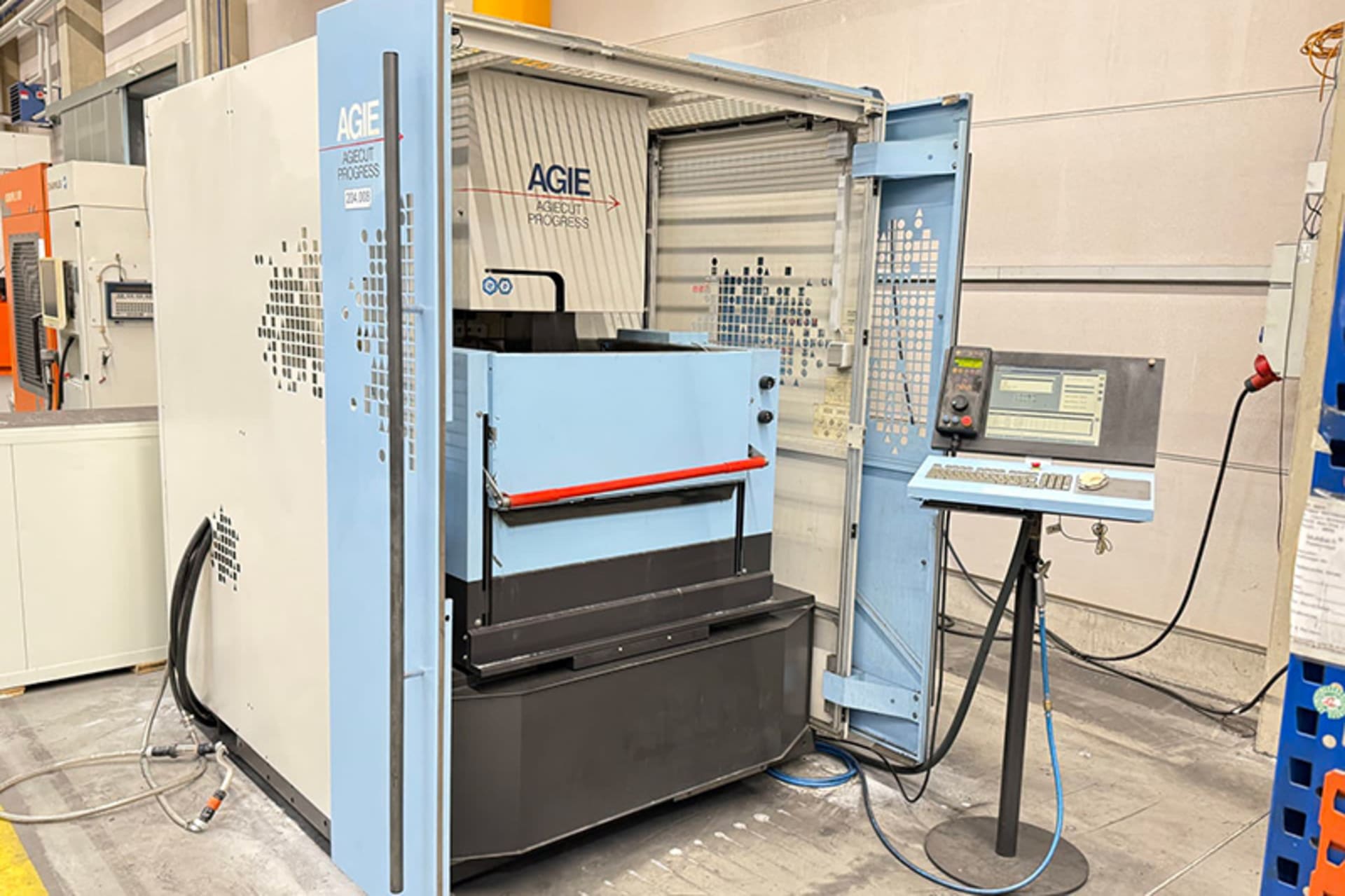 AGIE AGIECUT PROGRESS 2 Wire EDM Machine AGIE AGIECUT PROGRESS 2 wire EDM machine with open protective doors and a separate control panel on the right