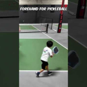 6 year old kid practicing massive forehand for pickleball