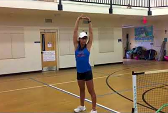 Coach Mei Shen teaching stretching to help stop Pickleball injuries