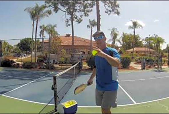 Coach David Wyrsch instructing Brenda on how to do the crosscourt dink shot in pickleball