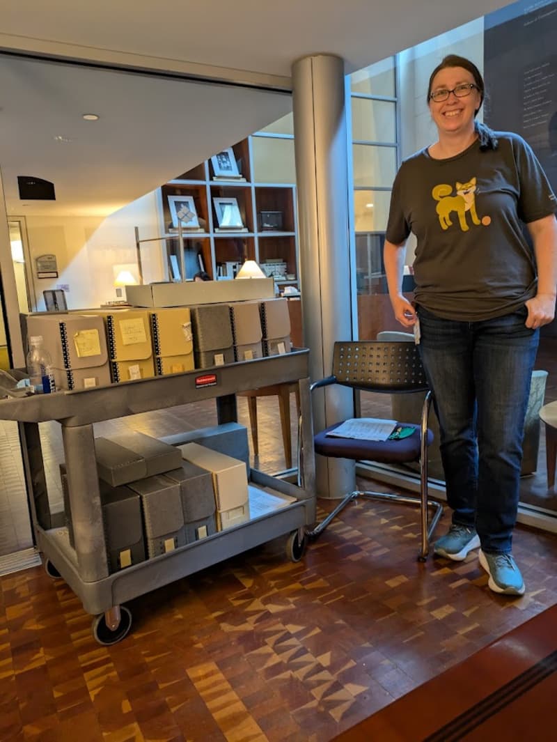 The archivist Jaime with boxes of artifacts