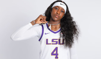 Flaujae Johnson holding chain that has number 4 while wearing number 4 jersey Flau'jae Johnson Blends Sports and music with Lil’ Wayne Collaboration 