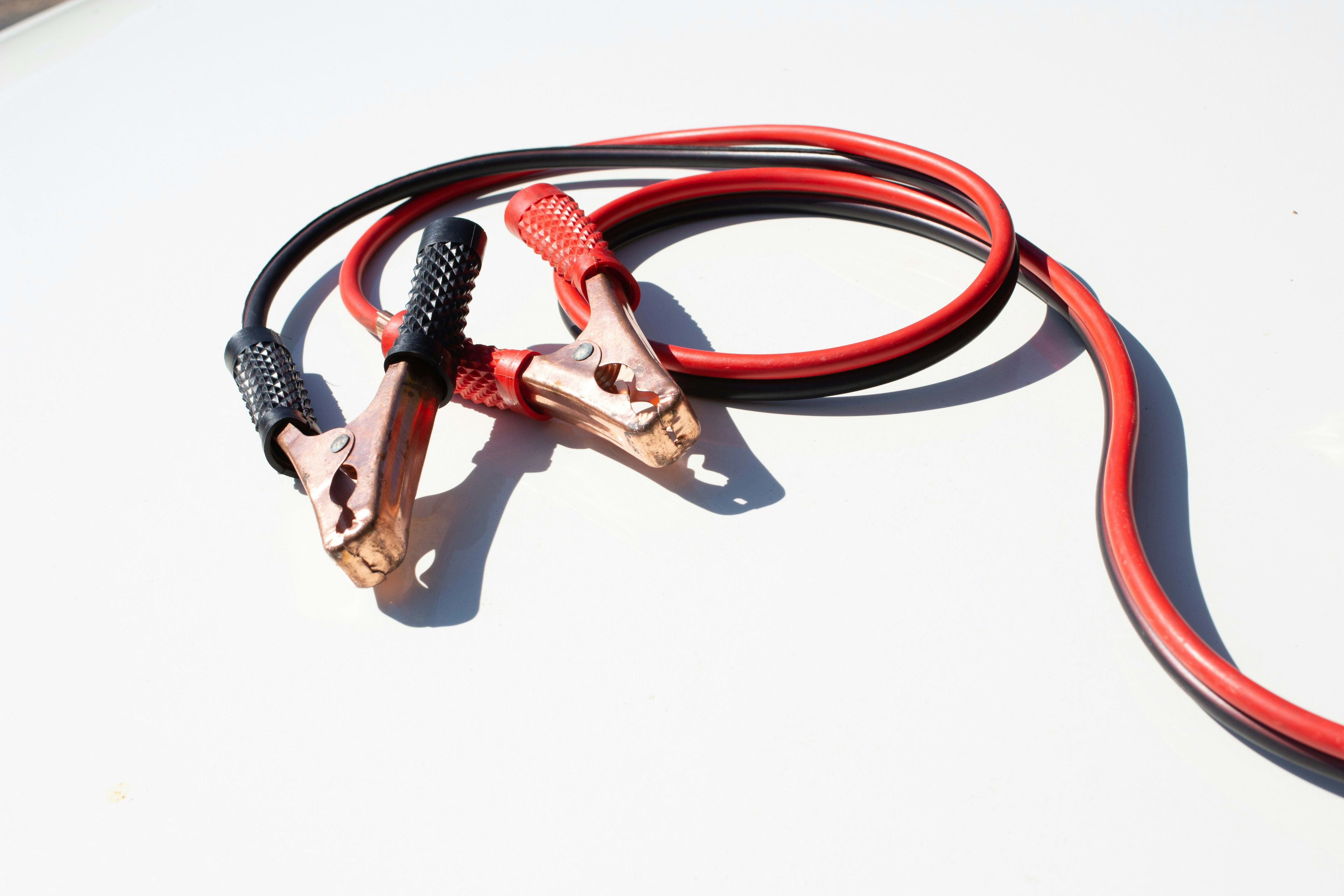 Jumper cables connecting to a car battery