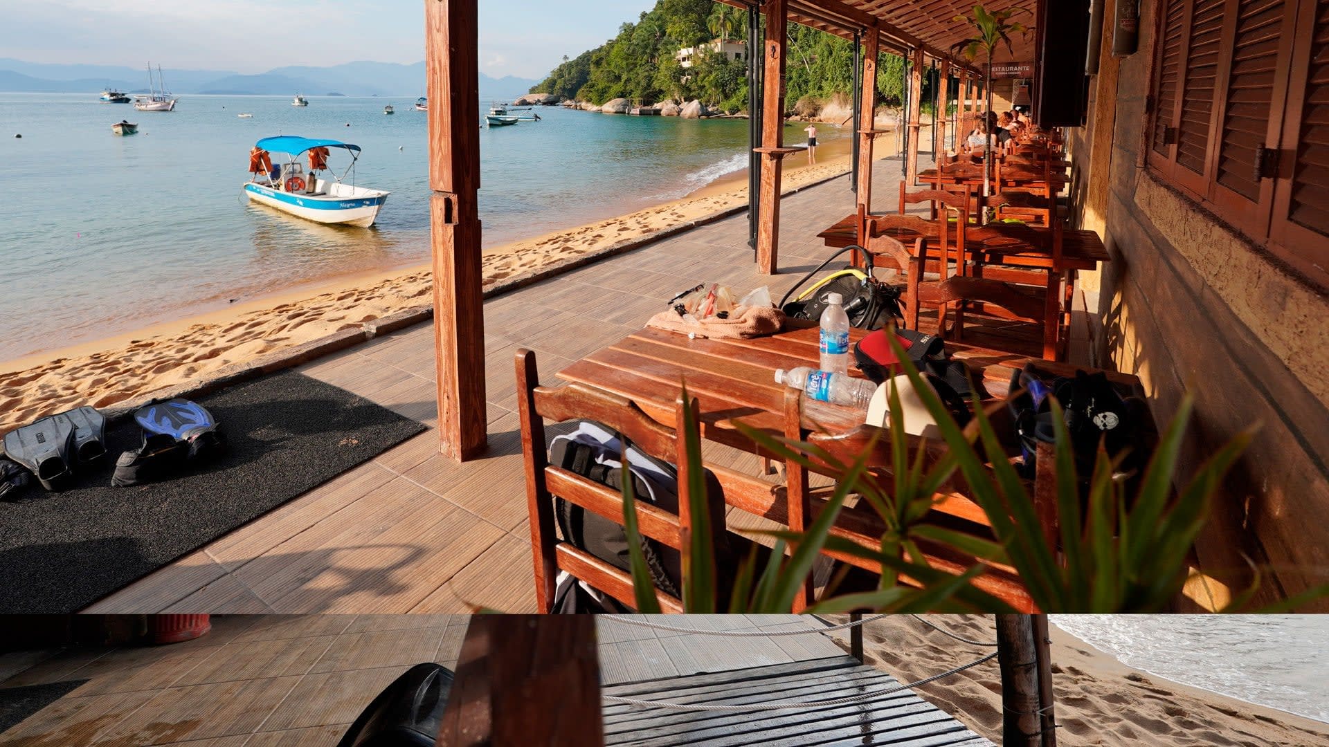 Deck do restaurante da pousada, com equipamento de mergulho e o mar em frente