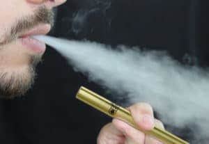 CBDfx vape pen. Man smoking CBDfx vape pen. CBD helping solve the vape crisis