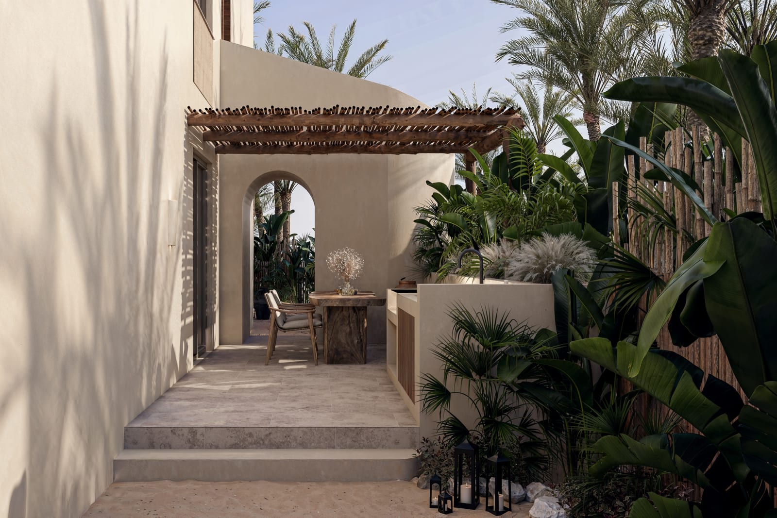 The garden path to a Loft Villa, under a timber pergola among palms