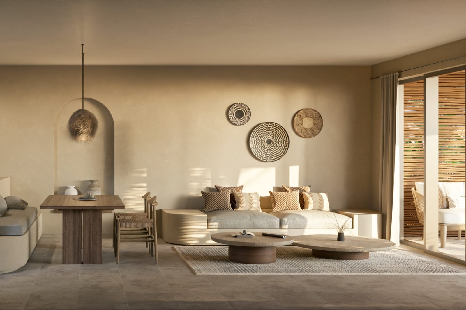 The living room of a Loft Villa: low sofas, a dining table and woven plates on clay walls, sliding doors to the garden