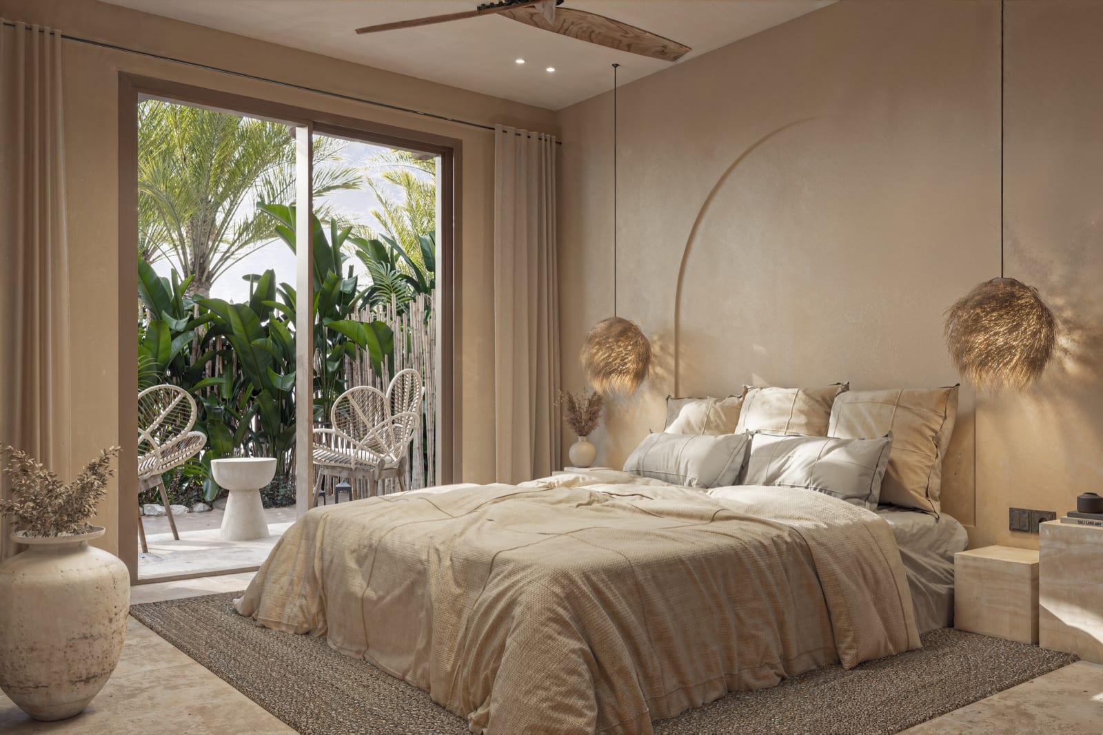El dormitorio de una Loft Villa, con las puertas correderas abiertas al jardín