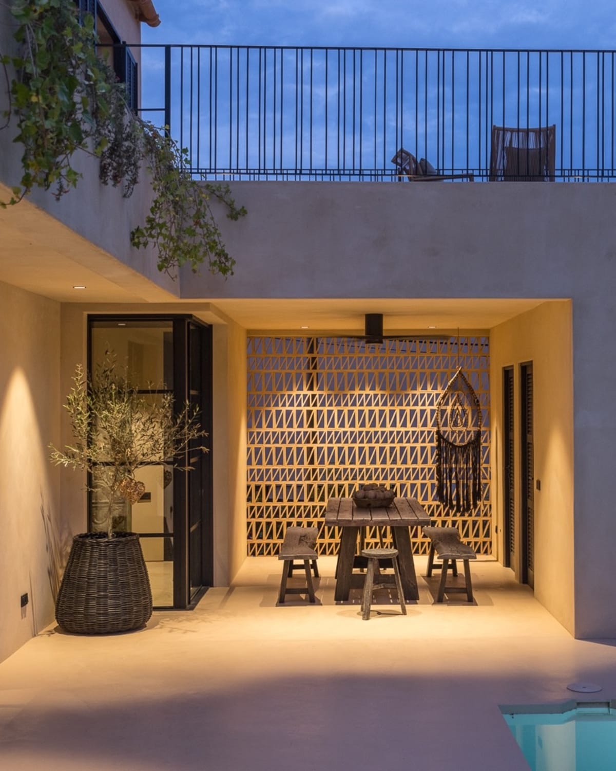Covered outdoor dining corner beside the pool, with a patterned screen wall, Falco 10