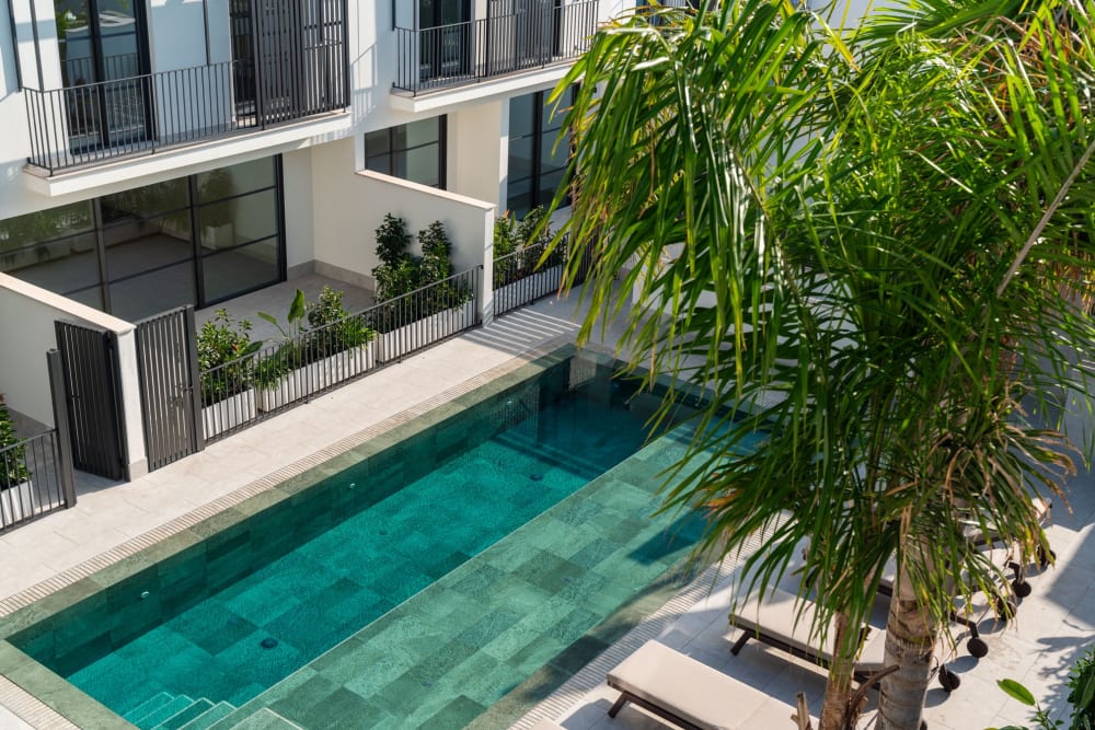 Der gemeinsame Pool in seiner Länge, Liegen und die Häuser dahinter, Reihenhaus in Portixol