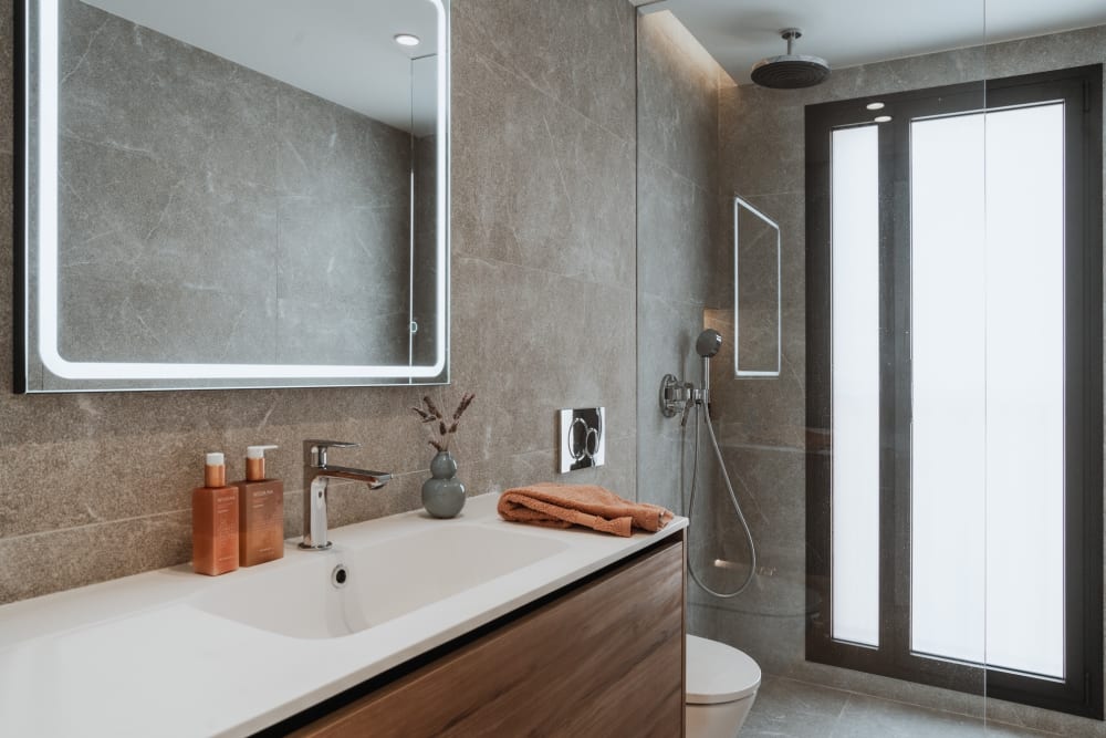 Ein Badezimmer, das Waschbecken, die Dusche und ein hohes Fenster, Reihenhaus in Portixol