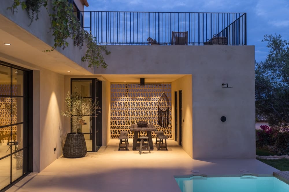 Covered outdoor dining corner beside the pool, with a patterned screen wall, Falco 10