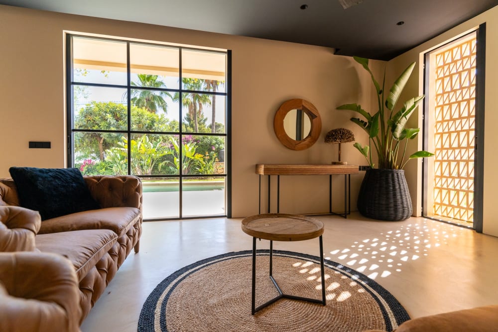 Living room looking through steel-framed glass to the garden and the pool, Falco 10