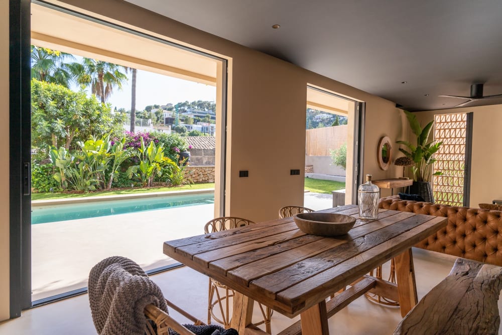 Dining table beside an opening onto the pool, Falco 10