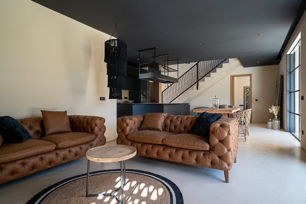 Two leather sofas in the living room, with the stair and the kitchen beyond, Falco 10