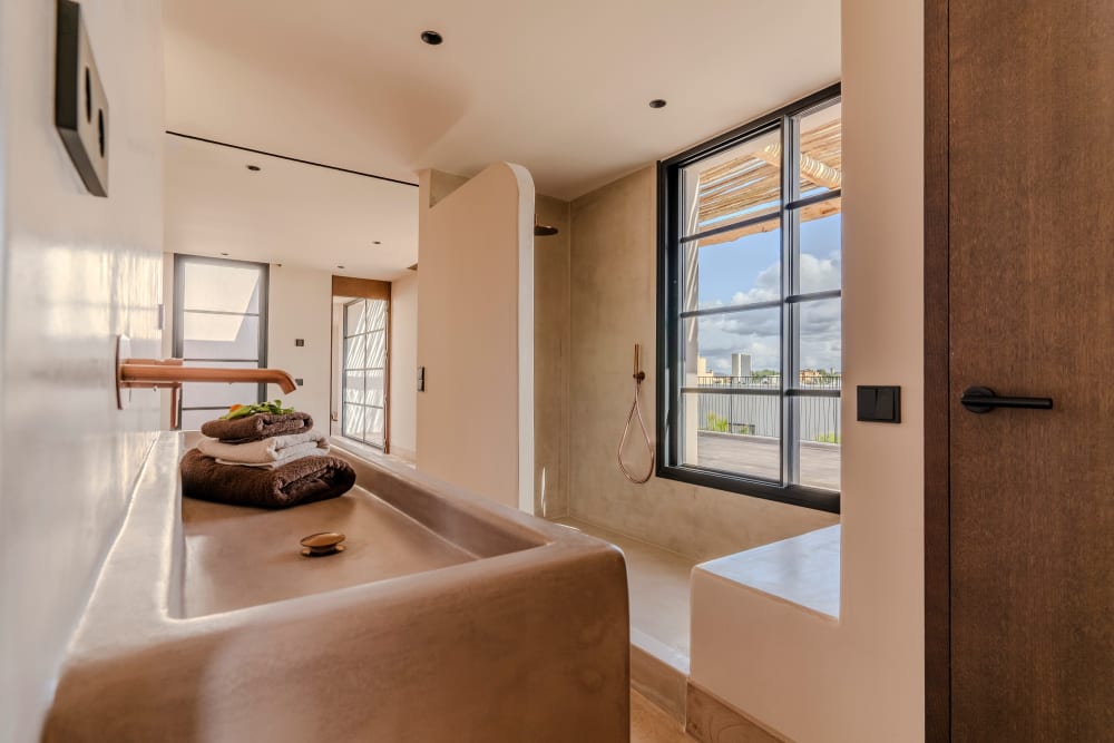 Bathroom with a stone trough sink and an open shower, Falco 13