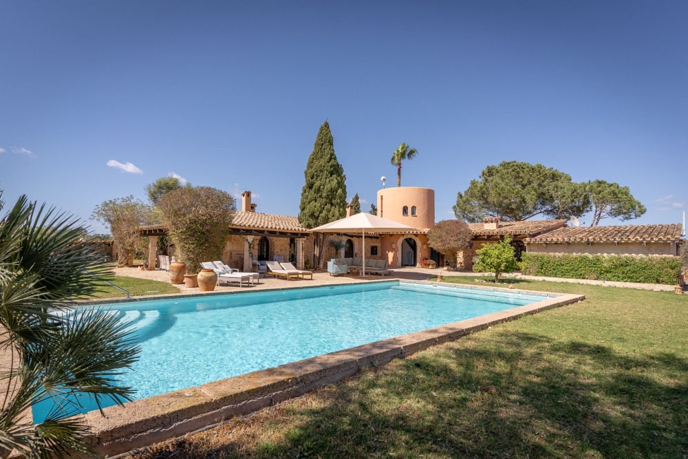 The saltwater pool in front of the stone house and its round tower, Hacienda Hermosa