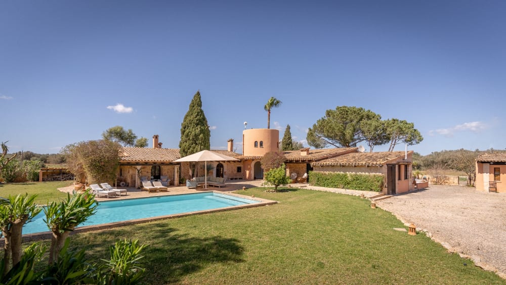 The house and pool seen across the lawn, with fields beyond the drive, Hacienda Hermosa