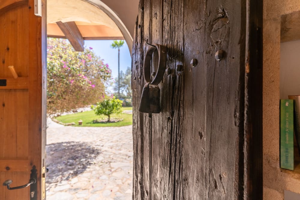 An old wooden door with an iron knocker, opening onto the garden, Hacienda Hermosa