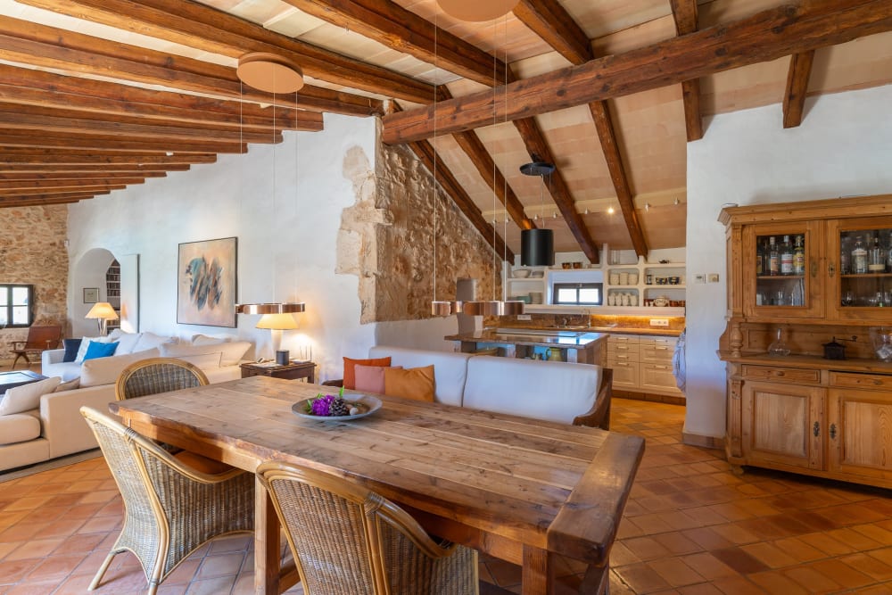 Kitchen and a long dining table under timber beams, Hacienda Hermosa