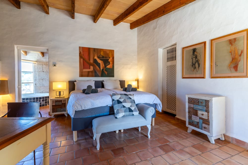Bedroom with a timber ceiling and a terracotta floor, Hacienda Hermosa