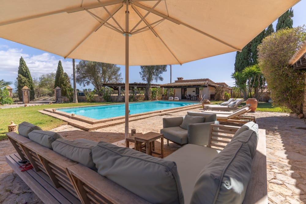 Seating under a canvas shade beside the pool, Hacienda Hermosa