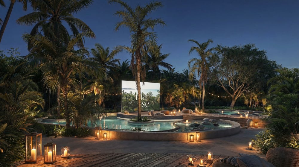 An outdoor cinema at night: a screen over a pool lit by lanterns among palm trees, Samaná Loft Villa · Render