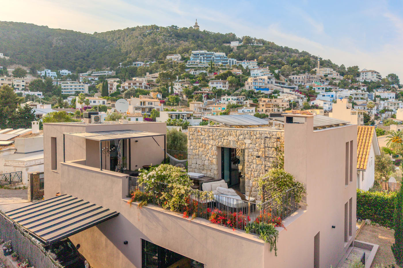 The house and its terrace seen from above, set in the Génova hillside