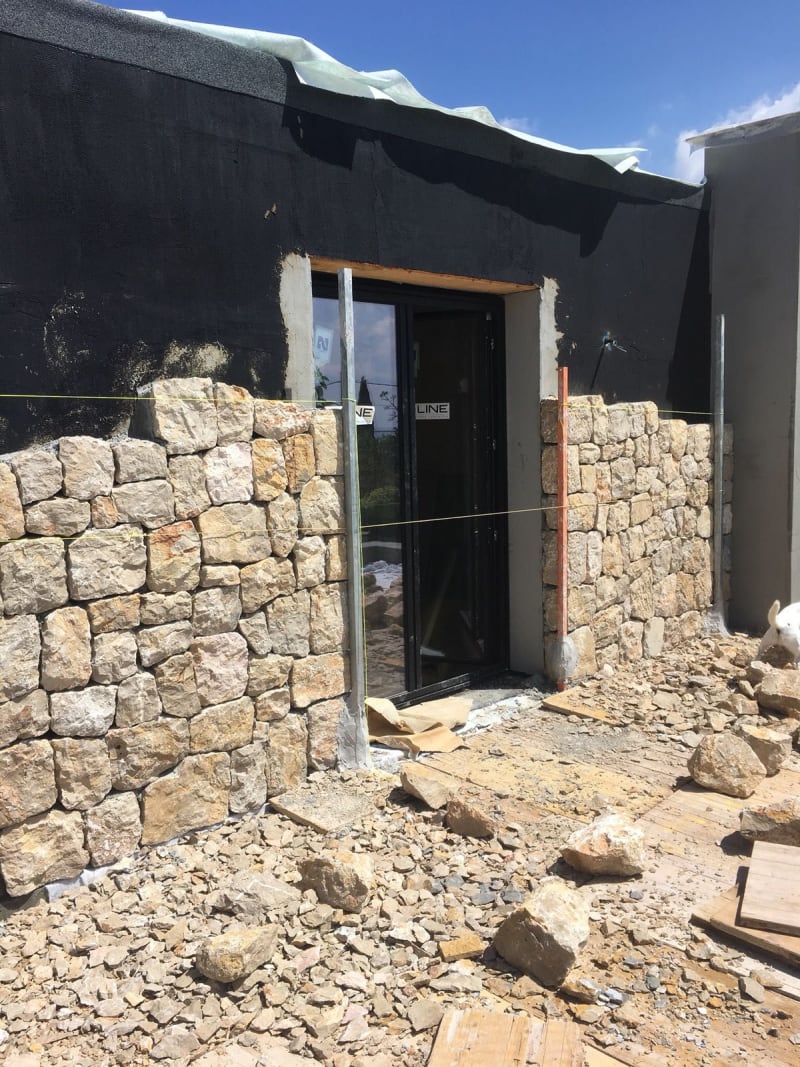 Hand-cut stones being set in the wall