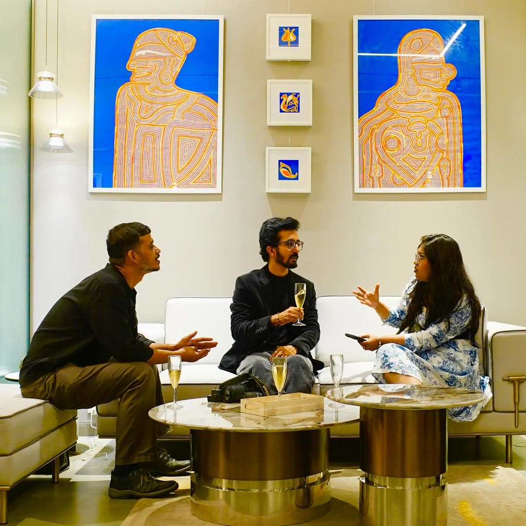 Visitors sitting and discussing art in gallery seating area