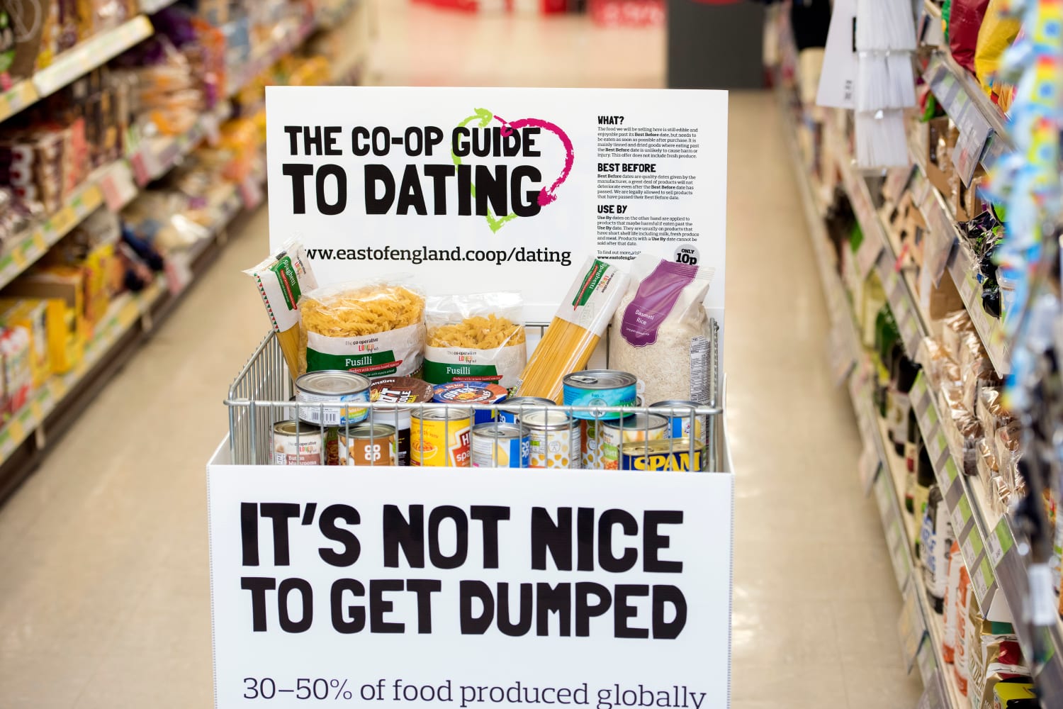 A food cage in a food store aisle, wrapped in campaign branding.
