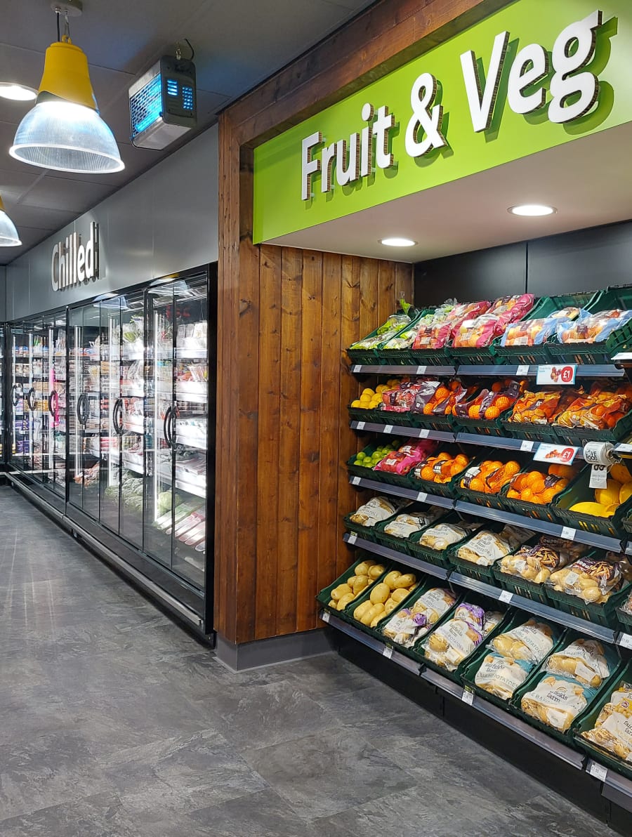 Close-up of the recycled cardboard category signage for the Chilled and Fruit & Veg sections..