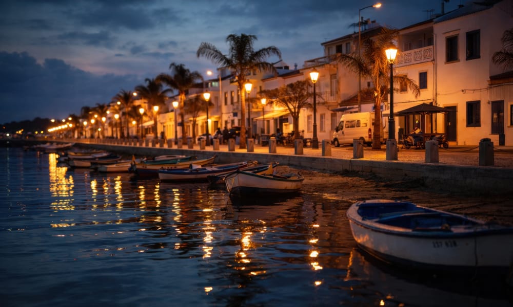 Traditional fishing town Santa Luzia waterfront illuminated at evening