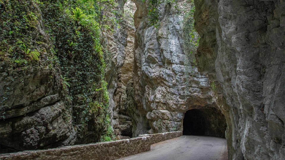 Road through a Natural Rock Tunnel in Alto Garda
