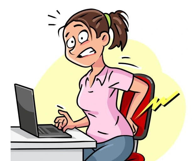 Person sitting at desk working on computer for long hours
