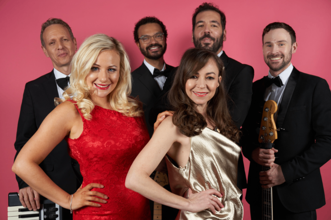 Gotta Be Garage: Six band members posing in formalwear against a pink studio backdrop