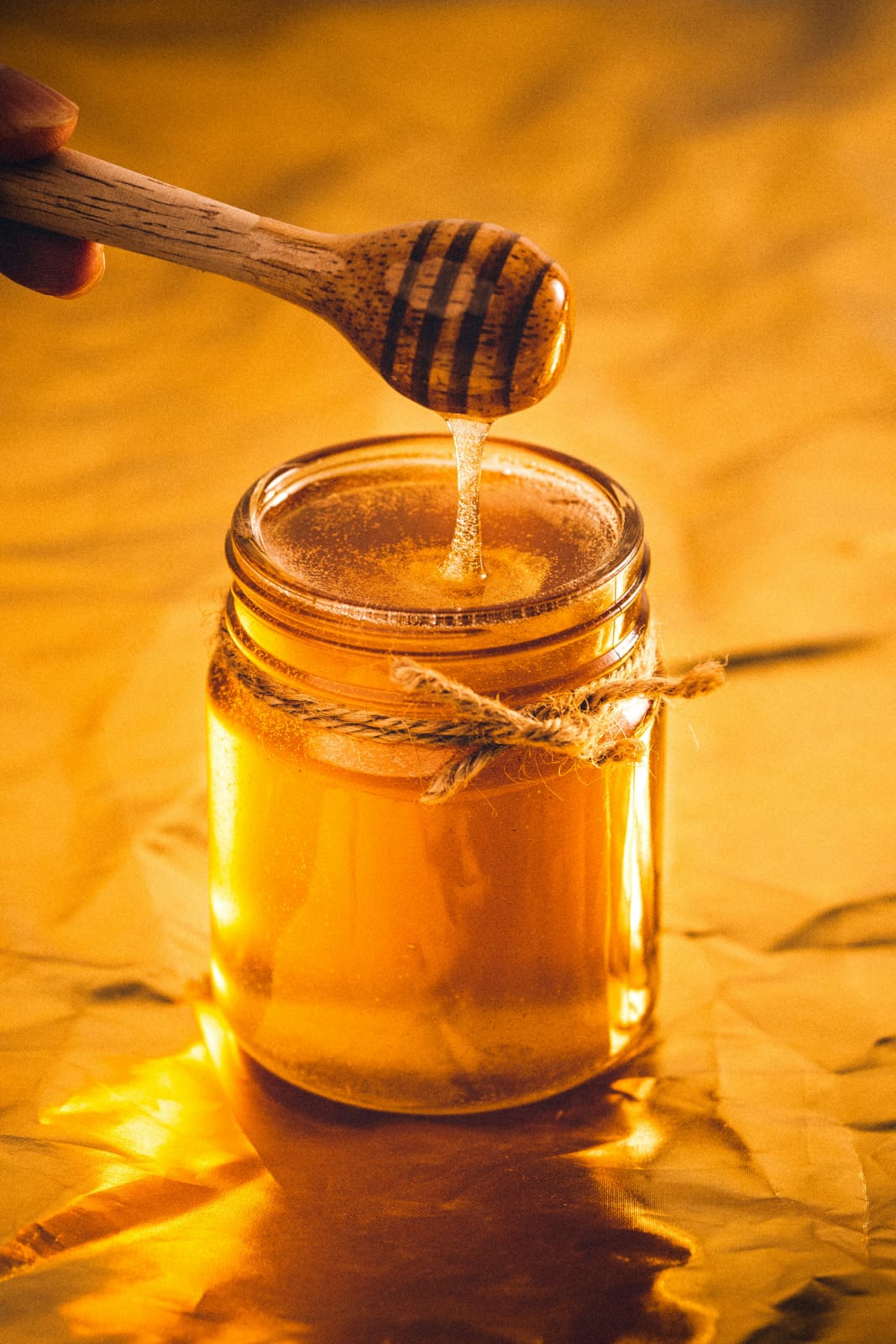 Raw honey collected naturally from honeybees and stored in a glass jar.