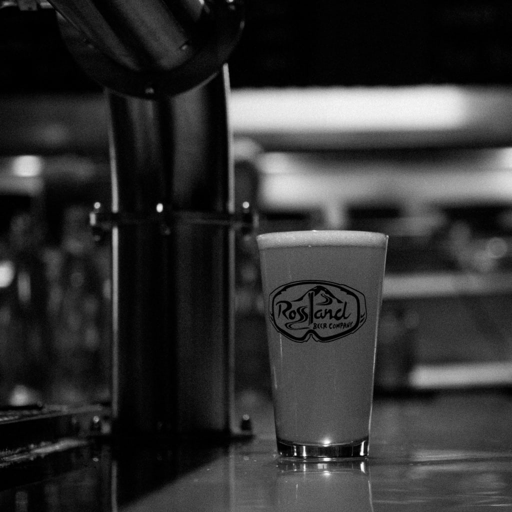 black and white picture of a beer with the Rossland Beer Company logo