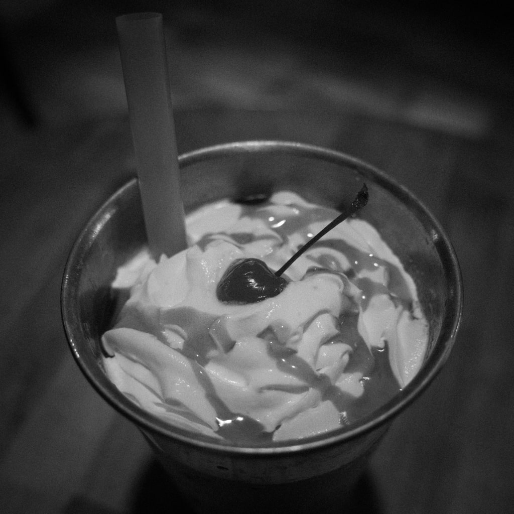 black and white picture of a milkshake