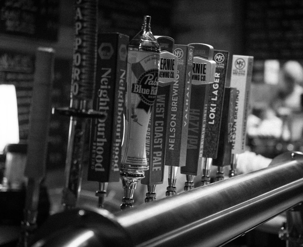 black and white picture of beer taps