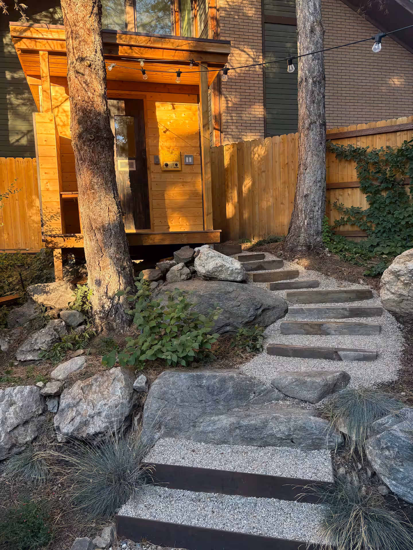 Spacious wooden deck with seating overlooking forested mountains