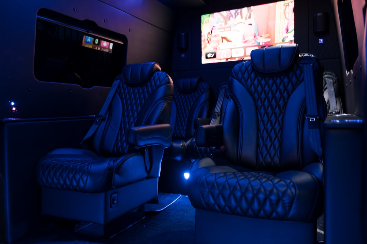 Quilted leather captain seats in the Monaco Sprinter, with a screen on the front wall