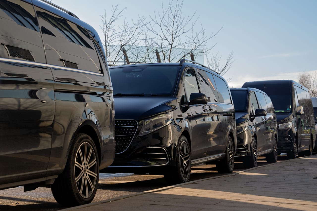 Black Mercedes V-Classes lined up at the kerb