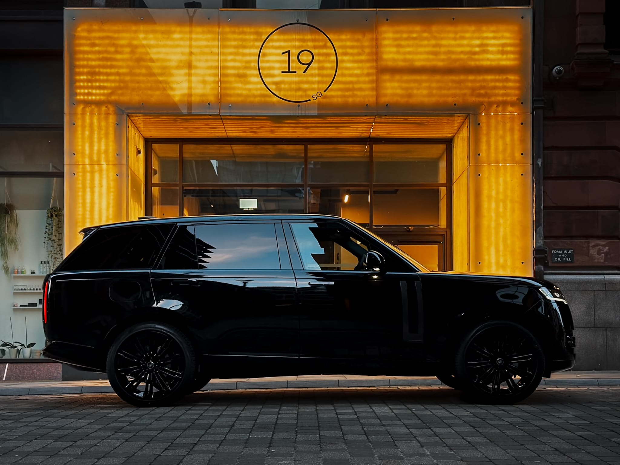 Executive chauffeur opening door for corporate client