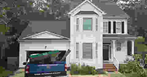 Professional Cova Roofing service truck at residential home with new roof installation in North Carolina