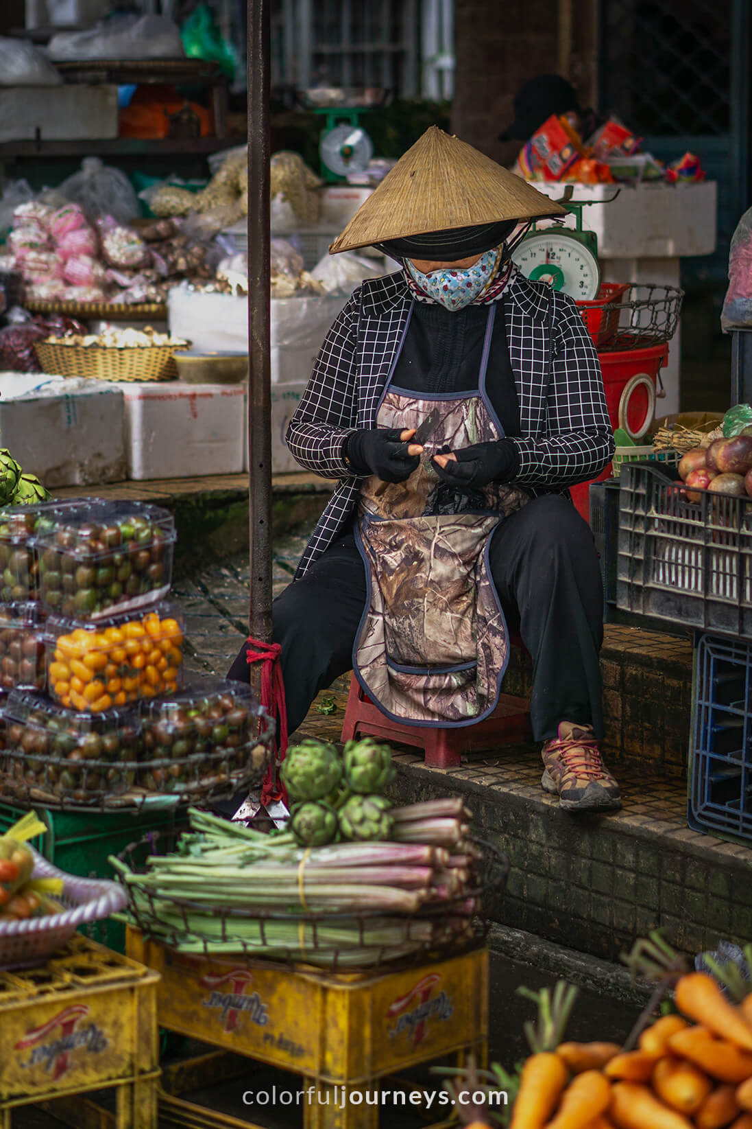 A woman sells goods at a market in Dalat, Vietnam.