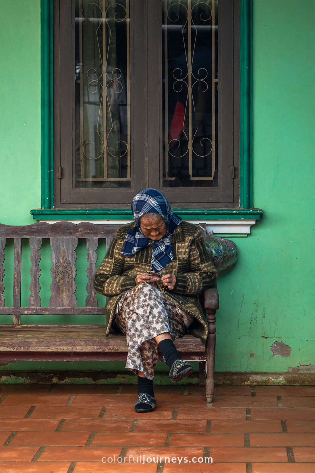 A woman sits on a bench in Dalat, Vietnam.